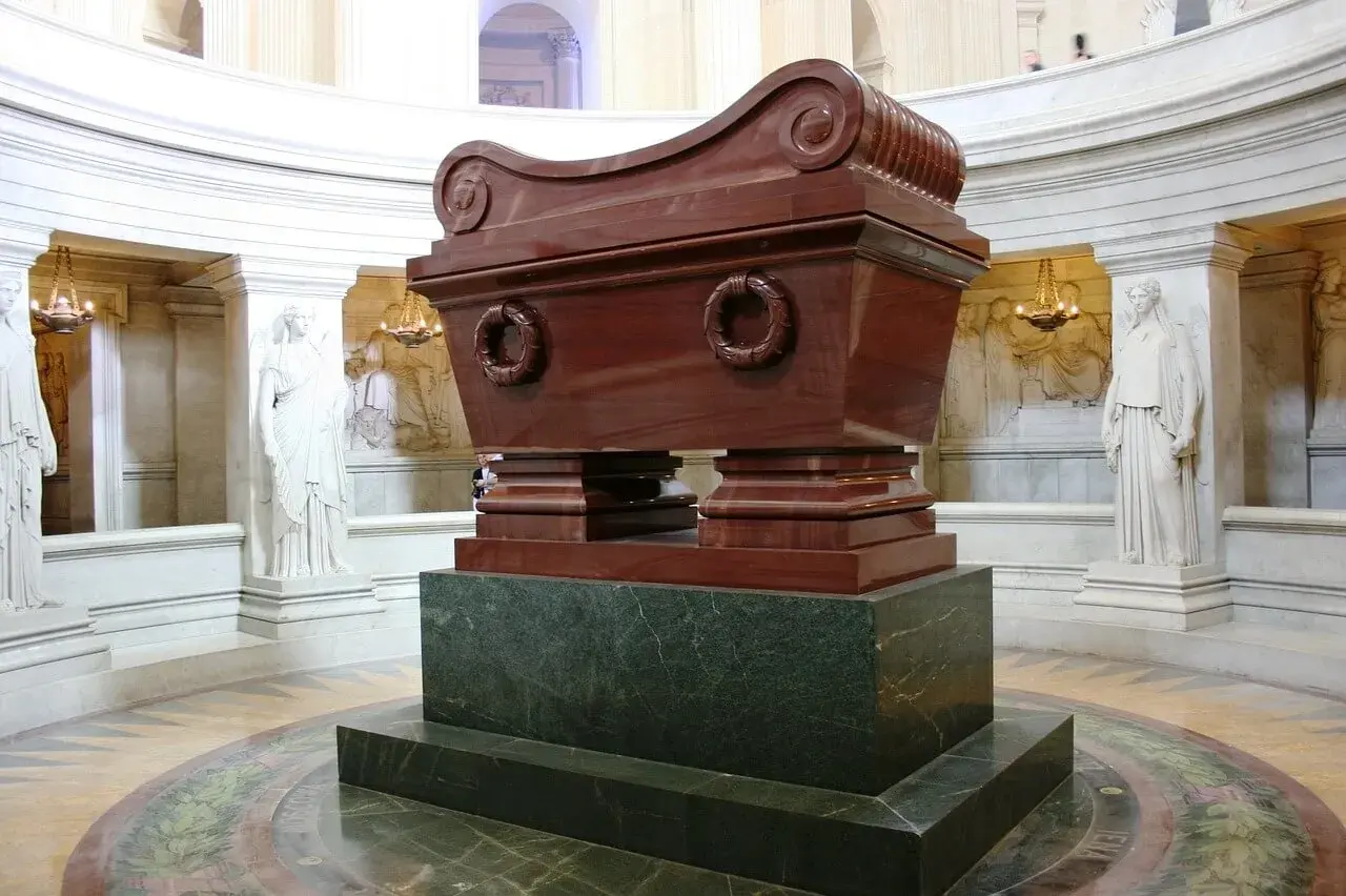 Grobowiec Napoleona w paryskim Invalides. Monumentalny sarkofag z czerwonego porfiru, otoczony rzeźbami.